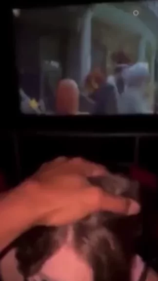 Dark haired girl sucks a black cock in the cinema in public